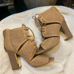 Nude lace-up heels with gold plate on front of heel for sale.